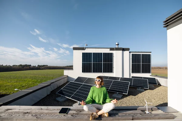 Young Woman Meditates Rooftop Her House Solar Power Plant Background — Foto Stock