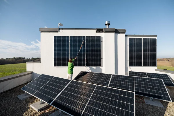 Woman Washing Solar Panels Brush Rooftop Her Household Sunny Day — Foto Stock