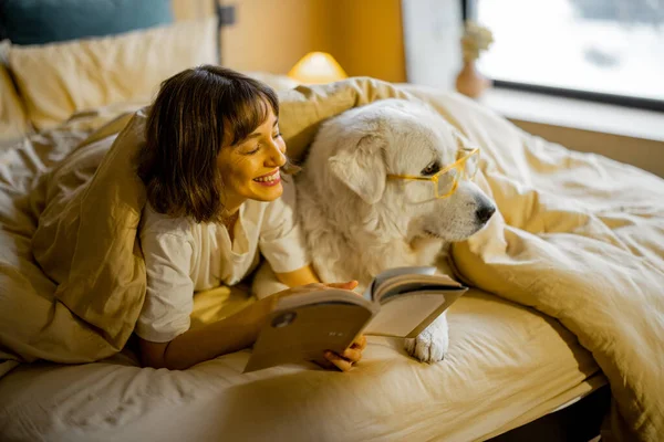 Young Woman Her Cute Dog Eyeglasses Reading Book While Lying — 스톡 사진