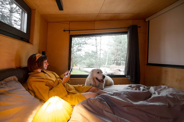 Woman Uses Phone While Lying Bed Her Cute Dog Tiny — Stok fotoğraf