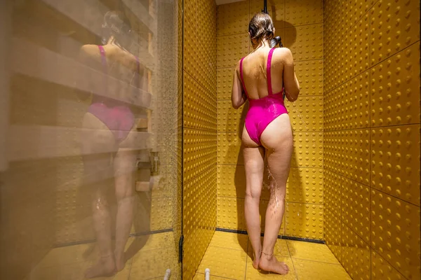 Woman Pink Swimsuit Relaxes Enjoys Taking Shower Yellow Tiled Shower — Stock Photo, Image