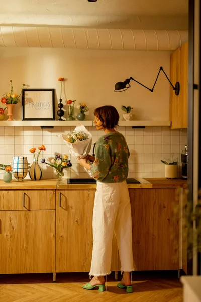 아름다운 부엌에 꽃다발을 만들어 아파트를 꽃으로 장식한다 — 스톡 사진