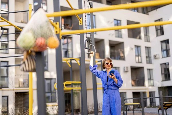 Woman Spends Leisure Time Sports Ground Apartment Building Standing Phone — Stock Photo, Image