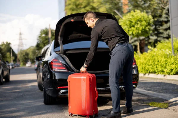 Sjåføren Til Bil Forretningsklasse Pakker Rød Koffert Inn Bagasje Gaten – stockfoto