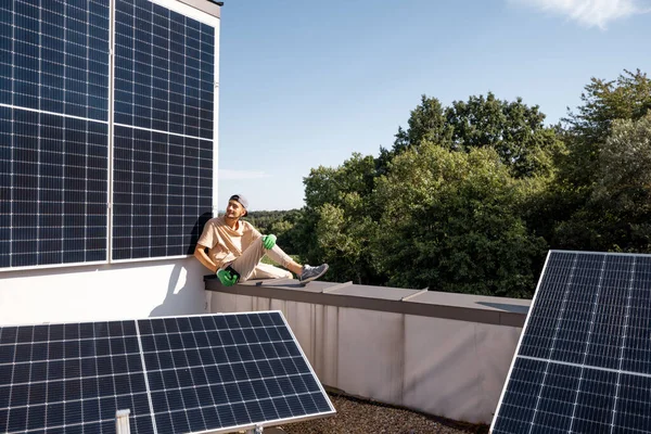 Man Sitting Rooftop His House Solar Power Station Installed Renewable — Stock Photo, Image