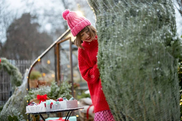 Young Woman Red Sweater Hat Unpacks Christmas Tree Packing Net — Stock Photo, Image