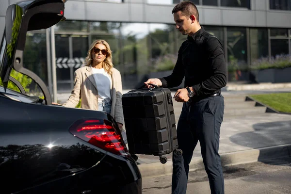 Chauffeur Packs Suitcase Car Trunk Businesswoman Waiting Nearby Using Luxury — Stock Photo, Image