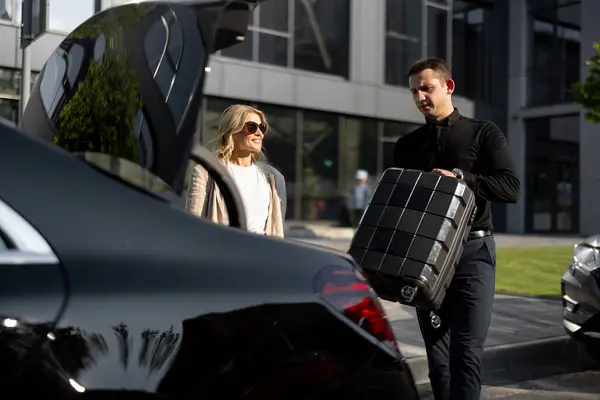 Businesswoman Waits While Chauffeur Packs Suitcase Car Trunk Using Luxury — Stock Photo, Image