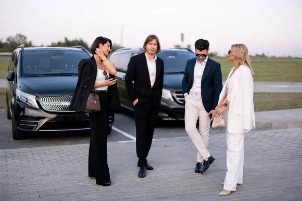 Gruppe Elegante Forretningsfolk Har Samtale Mens Står Sammen Parkeringsplass Nærheten – stockfoto