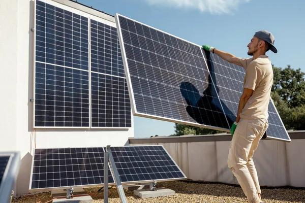Mannen Bærer Solcellepanel Mens Han Installerer Solcelleanlegg Taket Sin Eiendom – stockfoto