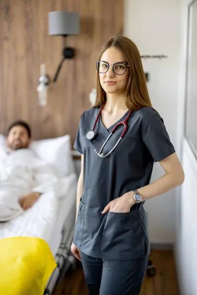Portrait Young Female Nurse Standing Medical Ward Patient Resting Background Stock Image