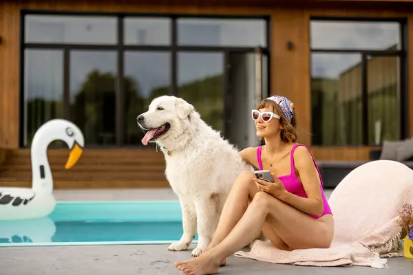Woman Hugs Her Cute White Dog While Relaxing House Swimming Royalty Free Stock Photos