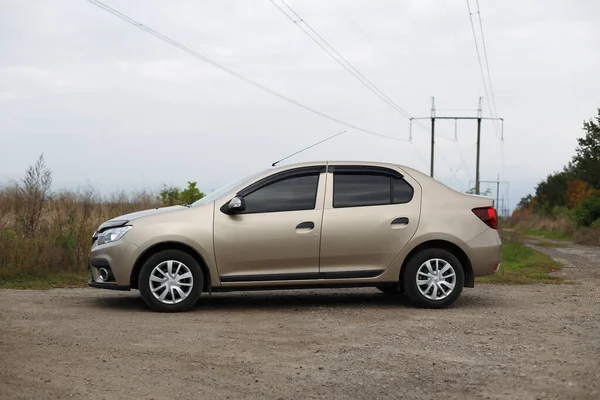 stock image Dnipropetrovsk region, Ukraine - October 09, 2022: Renault Logan 2020 golden color near the field