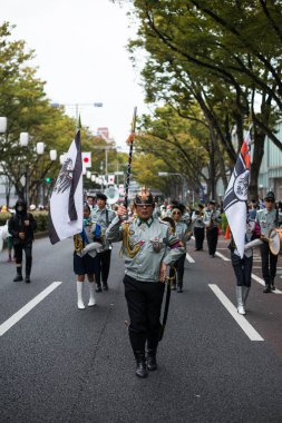 TOKYO, JAPONYA - 27 Ekim 2024 - Japon halkının Tokyo 'daki Omotesando Cadılar Bayramı' nda askeri kostüm giydiği dikey resim, Harajuku 'da her yıl düzenlenen bir etkinlik..