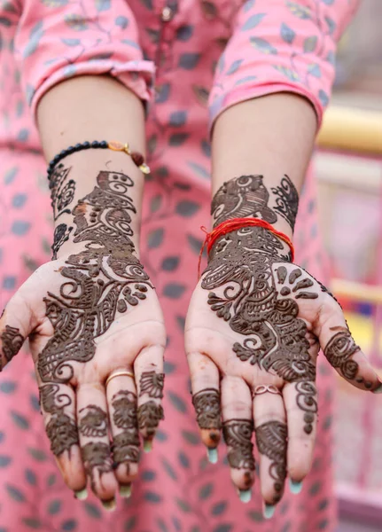 hand decorated with amazing henna tattoo or mehndi art from flat angle
