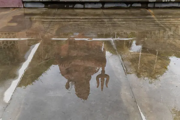 water reflection of hindu god lord shiva isolated statue at morning from unique perspective