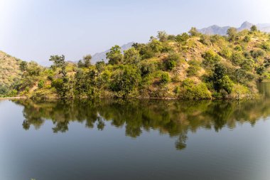 Gündüzleri orman yansıması olan el değmemiş bir göl.