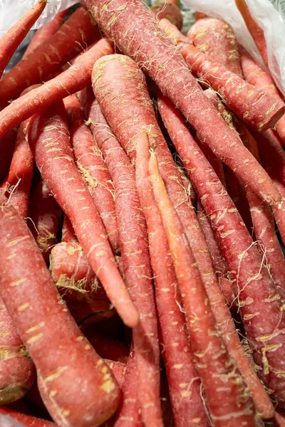 fresh carrots at vegetable store for sale at evening