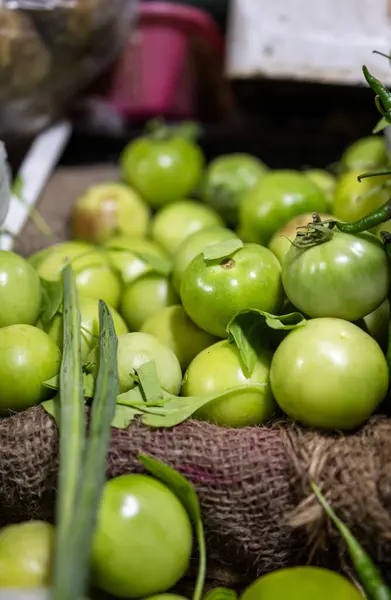 fresh green tomato at vegetable store for sale at evening