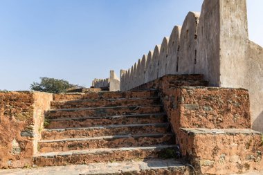 ancient fort wall ruins with bright sky from different perspective at morning image is taken at Kumbhal fort kumbhalgarh rajasthan india. clipart