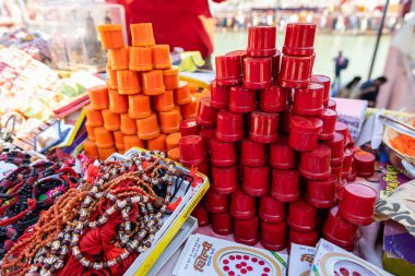 hindu holy vermilion kept for selling at street shop at morning clipart
