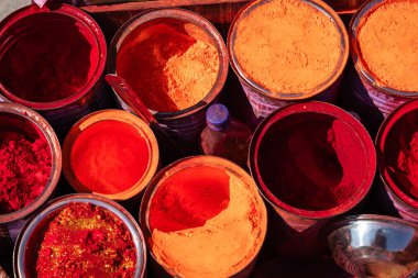 colorful vermilion kept for selling at holy place at street shop at morning clipart