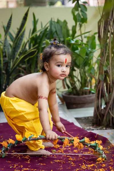 stock image Portrait of cute Indian boy dresses as lord rama with bow at outdoor with blurred background at day