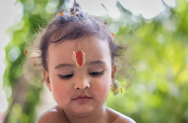 stock image cute Indian boy with holy religious symbol on head at outdoor with blurred background