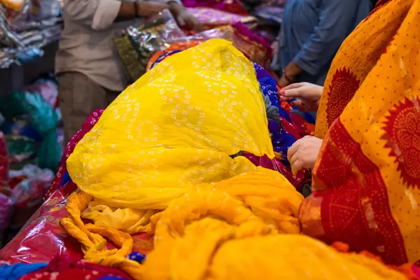 stock image retails clothe seller showing different kind of indian traditional dress saree to customer at shop