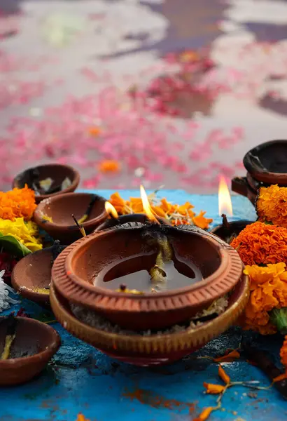 stock image holy offerings of burning clay oil lamp for hindu god at festival from unique perspective