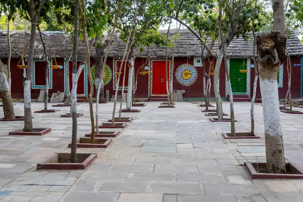 stock image colorful artistic designed traditional teak and bush home with green trees at courtyard at evening