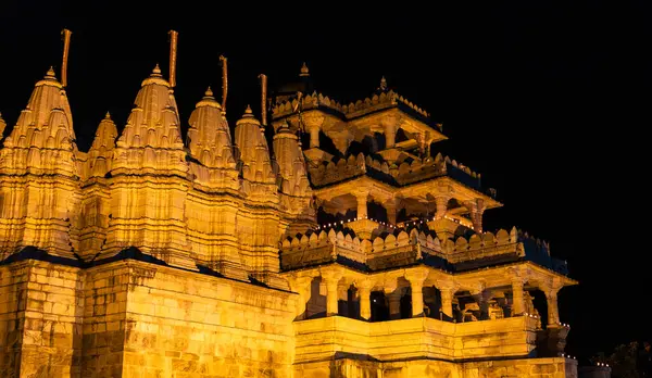 stock image illuminated ancient unique temple architecture at night from different angle image is taken at ranakpur jain temple rajasthan india.