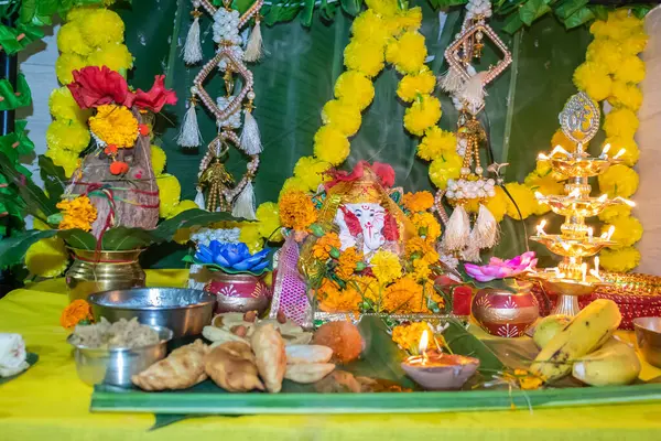 stock image holy hindu god ganesha idol worship with holy offering and decoration at home at ganesh chaturthi