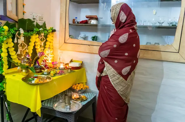 stock image devotee worship to holy hindu god ganesha idol with holy offering at home at ganesh chaturthi