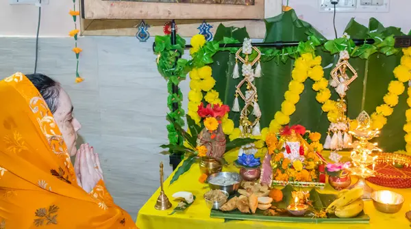 Stock image devotee worship to holy hindu god ganesha idol with holy offering at home at ganesh chaturthi