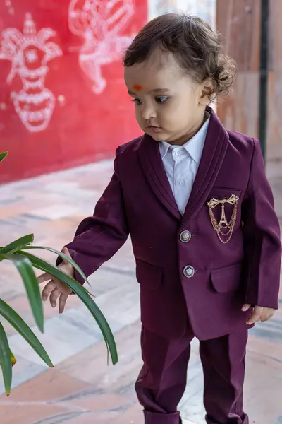 stock image cute indian toddler walking in suit with different facial expression at outdoor from flat angle