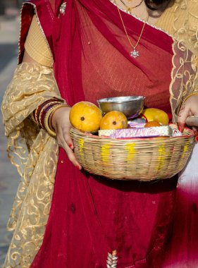 devotee holding holy offerings for worshiping of god at day on the occasion of Banyan tree worship festival, (Vat Savitri Puja) India. clipart