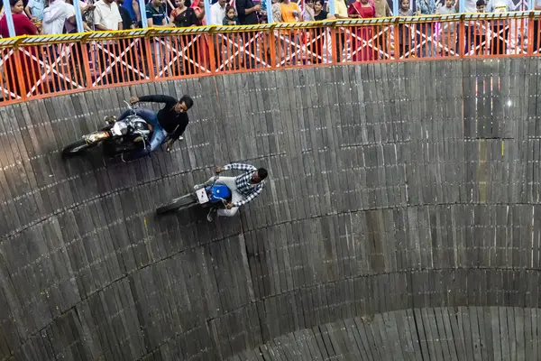 stock image daredevils bikers stunt at well of death or maut ka kuan show at evening video is taken at jodhpur local fair rajasthan india on Aug 19 2024.