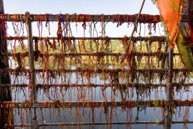 bunch of holy hindu thread offerings at religious temple clipart