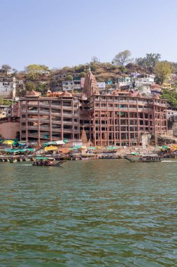 ancient hindu pilgrimage temple at holy river bank at morning from different perspective image is taken at omkareshwar khandwa madhya pradesh india on Mar 10 2024. clipart