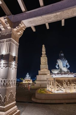 idols of hindu holy sage sitting in mediation at outdoor at night image is taken at mahakaleshwar mahakal temple corridor ujjain madhya pradesh india. clipart