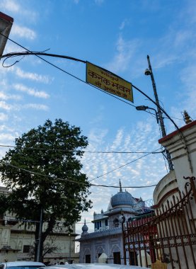 Sacred Hindu temple with its vibrant architecture and dramatic sky at evening clipart