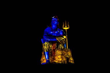 isolated Statue of Hindu God Lord Shiva in Meditation Posture with dramatic laser light effect clipart