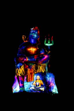 isolated Statue of Hindu God Lord Shiva in Meditation Posture with dramatic laser light effect clipart