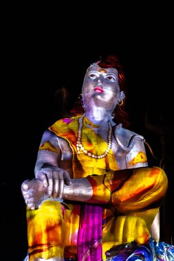 Statue of Hindu God Lord Shiva Ardhnarishwar in Meditation Posture with dramatic laser light effect clipart