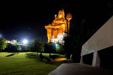 Isolated Statue of holy Hindu Lord Shiva in Meditation Posture with black dark sky at night clipart