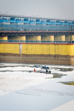 industrial and domestic effluents toxic foam of polluted river diluting by speed boat video is taken at yamuna river okhla barrage delhi india on Nov 04 2024. clipart