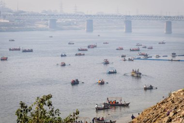 pilgrims on boat crossing sacred ganges river for triveni sangam at mahakumbh image is taken at mahakumbh mela prayagraj uttar pradesh india on Feb 17 2025. clipart