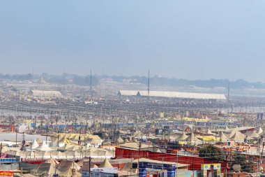 crowded temporary tent shelters with pontoon bridge over ganges river at mahakumbh festival image is taken at mahakumbh mela prayagraj uttar pradesh india on Feb 17 2025. clipart