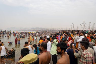 spiritual gathering of devotees at triveni sangam at mahakumbh festival at day image is taken at mahakumbh mela prayagraj uttar pradesh india on Feb 17 2025. clipart